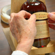 A bottle of Templeton Rye is labelled by hand.
